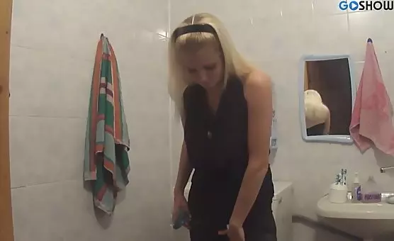Blonde Temptress Spreads Delights with Dildo in Bathroom